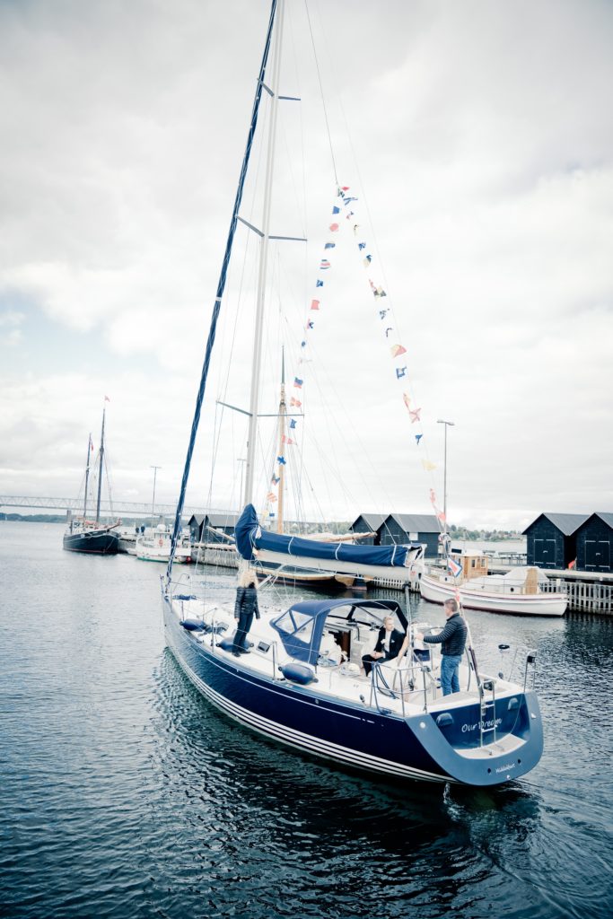 White sailing yacht with water in the background